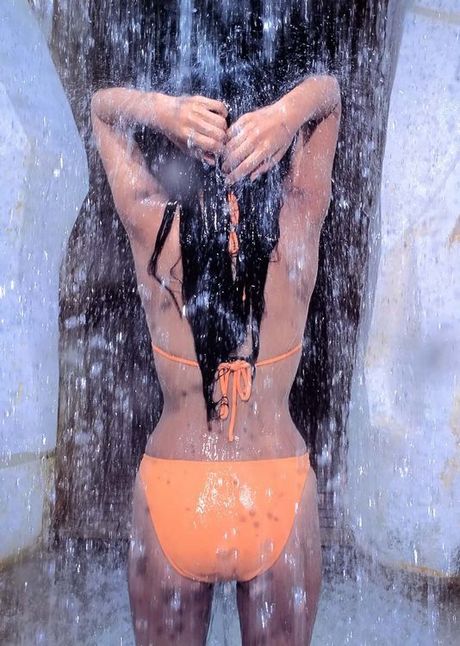 Alluring asian beauty with large heavy breasts in a bikini