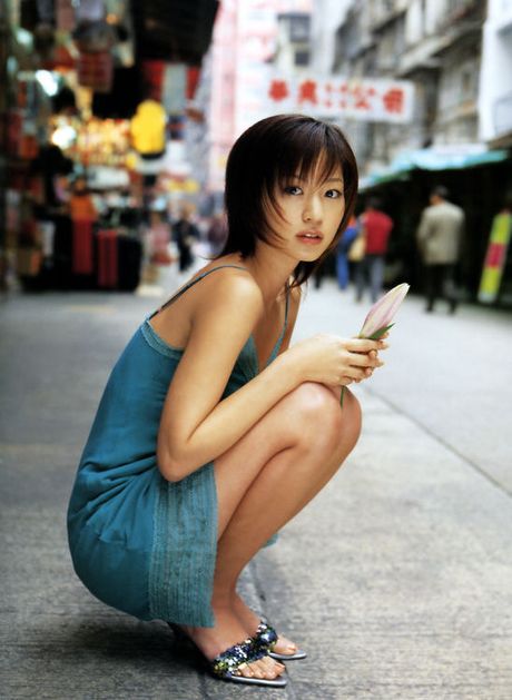 Beautiful gravure model with petite perky tits in a yellow bikini