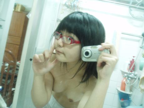 fat teen poses in the mirror with small tits