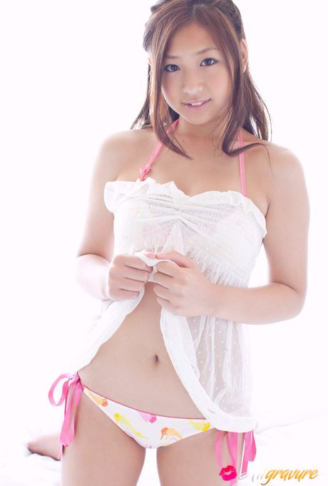 Ayaka Sayama Asian smiles while revealing curves in red lingerie