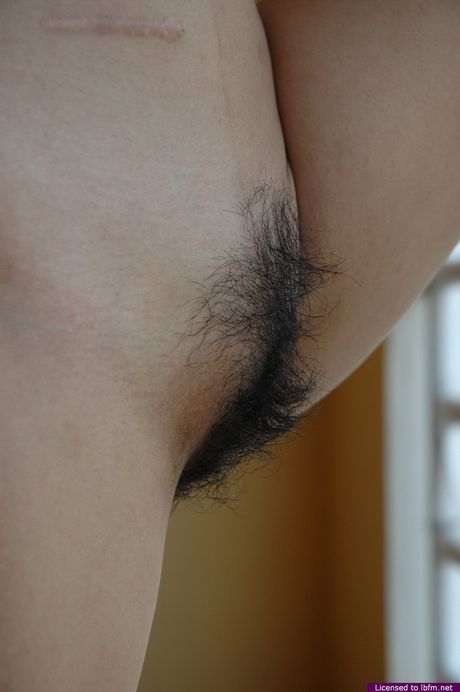 Skinny Asian amateur teen strips and shows her hairy pussy up close