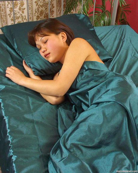 Asian teen with tiny tits and a big ass toying her pussy with a dildo