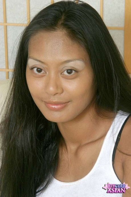 Amateur Asian girl with tiny tits strips and rubs her twat on the bed