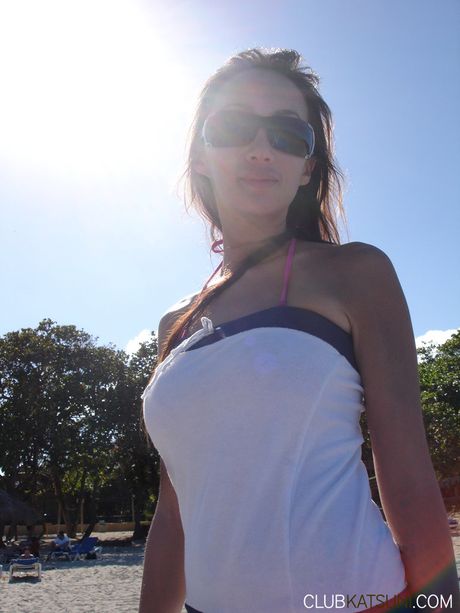 Asian cougar Katsuni strips off her bikini and highlights her perfect ass on the beach