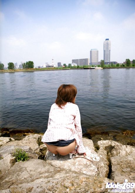 Appealing japanese hottie Hitomi Yoshino in sexy skirt exhibits big knockers and sexy butt outdoor